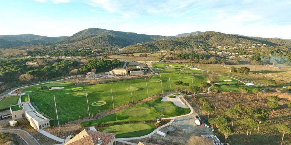 Detroit and all of Michigan Aerial view of a synthetic grass golf course surrounded by hills