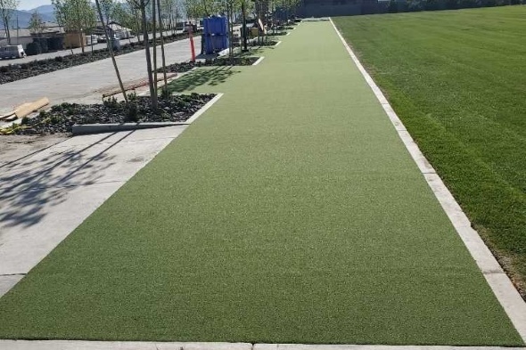 Detroit and all of Michigan Outdoor tee line consisting of one continuous green synthetic grass strip surrounded by trees